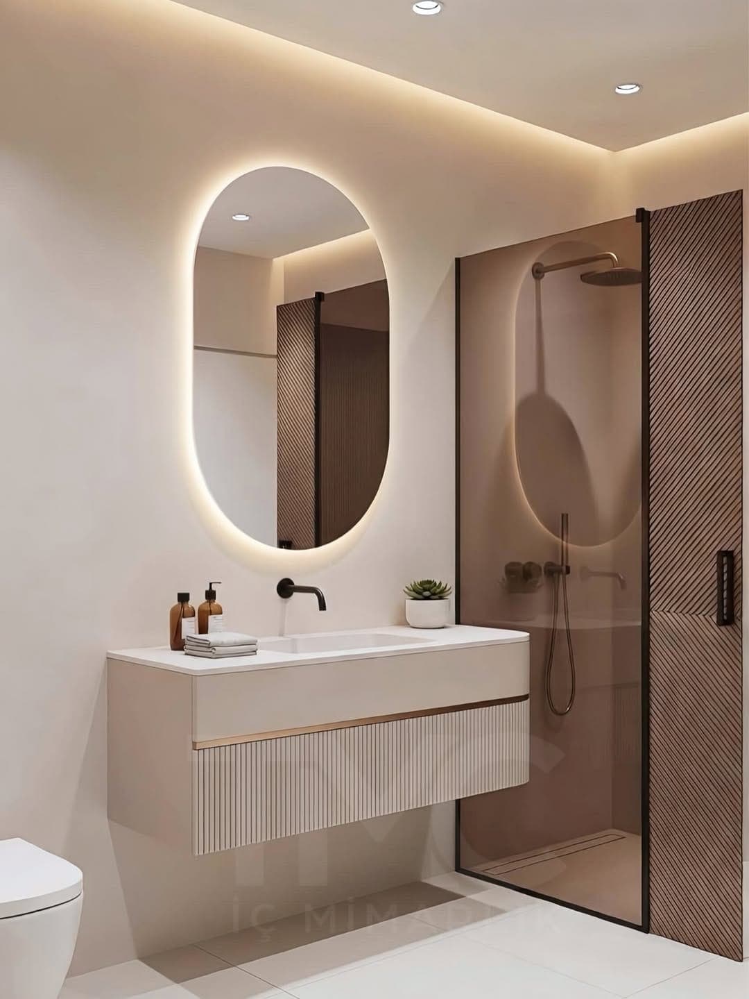 Modern Banyo Tasarımı | Oval LED Ayna, Nervür Cam ve Soft Bej Tonlar fonksiyonel kullanım ergonomisi ve mimari detay görünümü