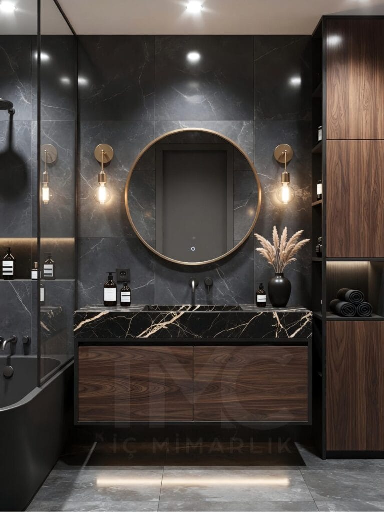 Toskana Vadisi Evleri’nde Selin & Emre için tasarlanan modern banyo; vizon tonlu dolap, mermer tezgah, arkadan LED aydınlatmalı oval ayna ve nervür panel detaylarıyla lüks ve sade iç mimari tasarım.