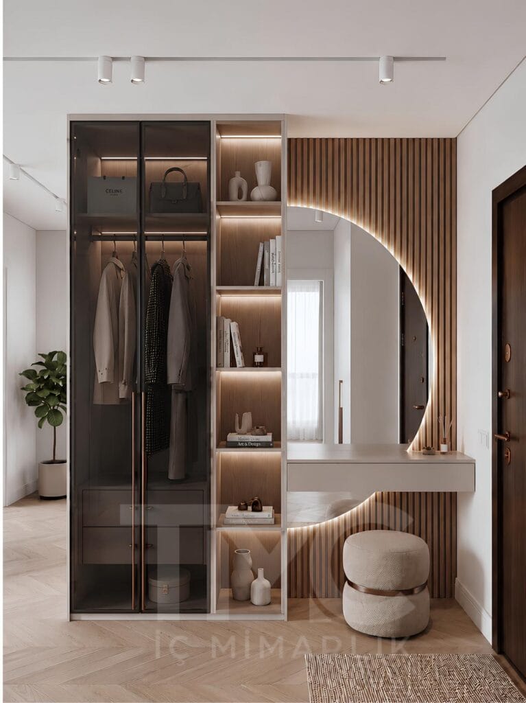 Modern antre tasarımı, özel üretim portmanto dolabı, LED aydınlatmalı dekoratif raf sistemi ve bronz detaylı ayna uygulaması ile tasarlanan Nuvo Dragos Duygu Hanım antre projesi. Açık krem tonları, doğal ahşap dokular ve modern çizgilerle tasarlanan giriş alanı, fonksiyonel depolama çözümleri ve premium iç mimari detaylarıyla dikkat çekiyor.