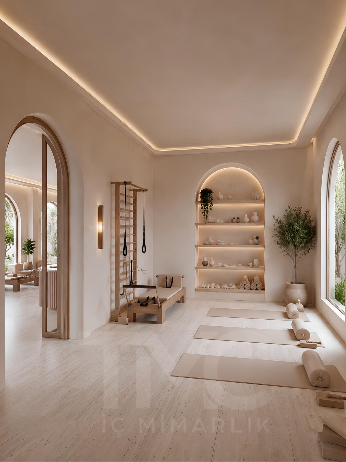 Modern pilates stüdyosu iç mimari tasarımı, doğal tonlarda butik pilates salonu dekorasyonu, kemerli mimari detaylı wellness studio tasarımı, sıcak LED aydınlatmalı pilates alanı, modern karşılama bankosu ve bekleme alanı tasarımı, açık bej renk paletli premium spor stüdyosu iç mekanı, TMC Mimarlık özel pilates stüdyosu projesi.